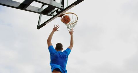 Basketball Player Scoring with Upward Shot on Outdoor Court