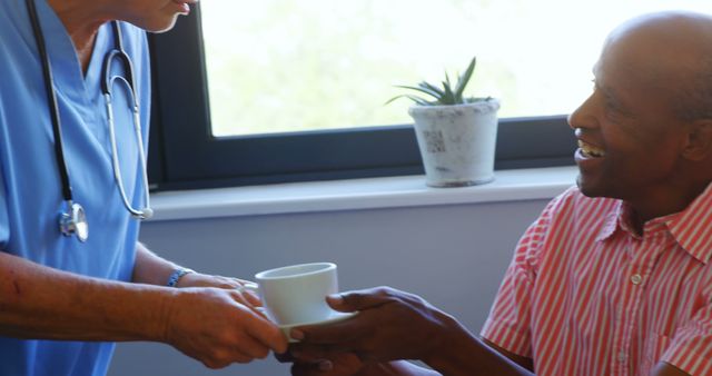 Nurse Offering Cup to Elderly Patient During Healthcare Visit - Download Free Stock Images Pikwizard.com