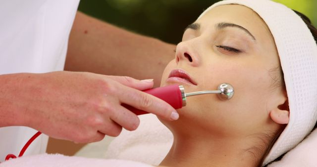 Pretty brunette getting micro dermabrasion treatment at the spa