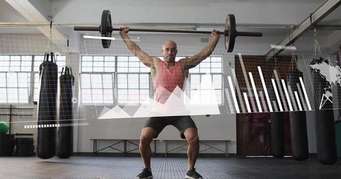 Athlete lifting barbell overhead in industrial gym with data graphs and analytics