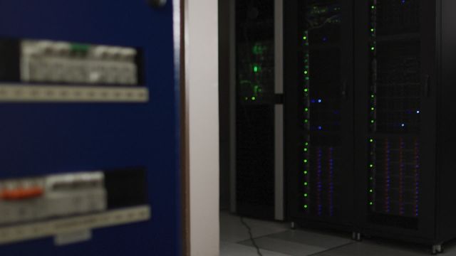 Server racks with flashing green lights in data center. Ideal for depicting IT infrastructure, data security, technological advancements, network management. Suitable for tech blogs, IT service promotions, and educational material on computer systems.