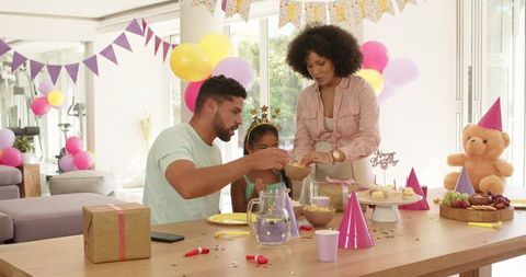 Diverse family celebrating a joyful birthday at home