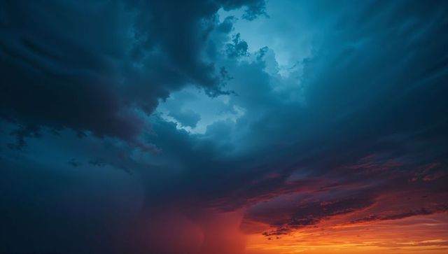 Dramatic storm clouds at sunset over vibrant horizon