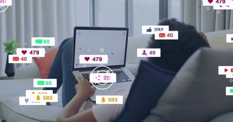 Relaxing woman on sofa using laptop with social media notification overlays