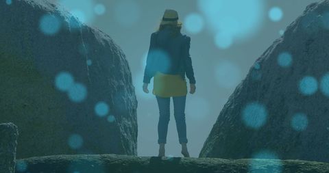 Woman exploring rocky terrain with dreamy glowing spots