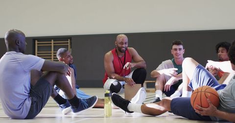 Diverse basketball team discussing strategy indoors