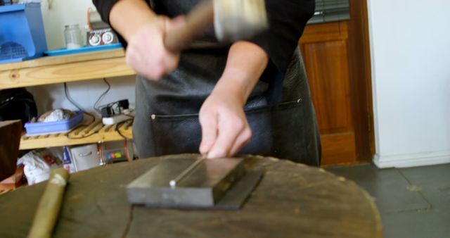 Jeweler Hammering Metal with Precision and Focus in Workshop - Download Free Stock Images Pikwizard.com