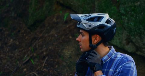 Caucasian Cyclist Fastening Helmet for Outdoor Adventure - Download Free Stock Images Pikwizard.com