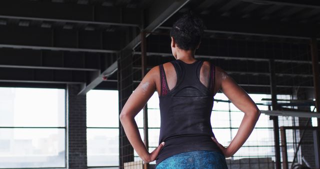 Confident Woman Reflecting at Gym with Hands on Hips - Download Free Stock Images Pikwizard.com