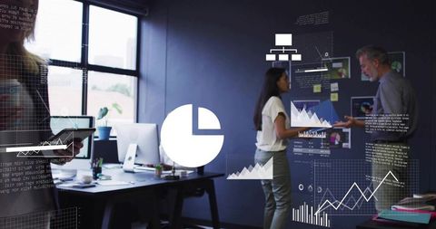 Professionals analyzing interactive data visualizations and charts in office collaboration