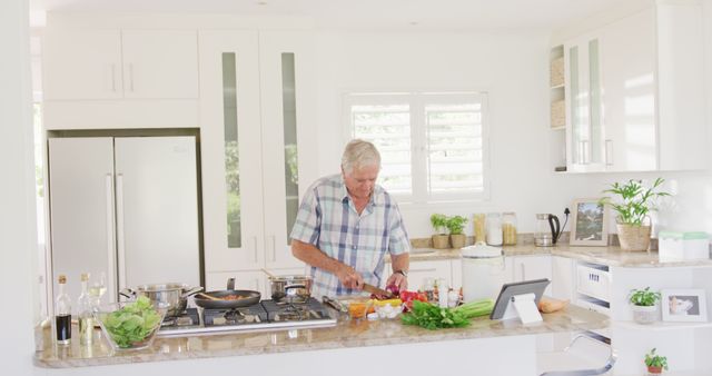 Happy Senior Man Using Tablet While Cooking in Modern Kitchen - Download Free Stock Images Pikwizard.com