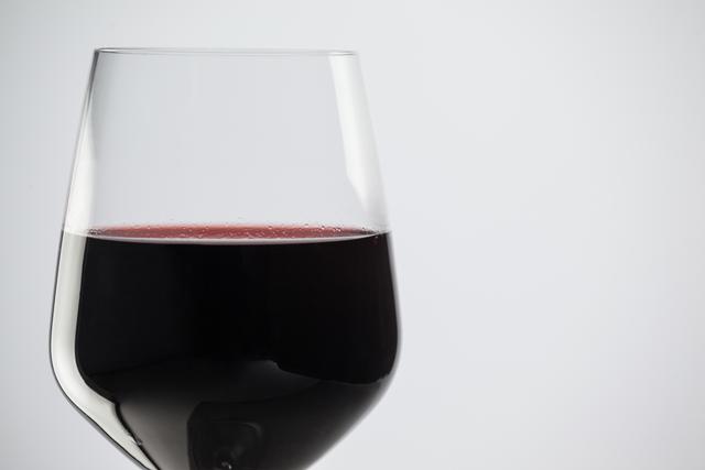 Glass of Red Wine Against White Background - Download Free Stock Photos Pikwizard.com