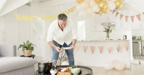 Mature man in modern home celebrating anniversary with style
