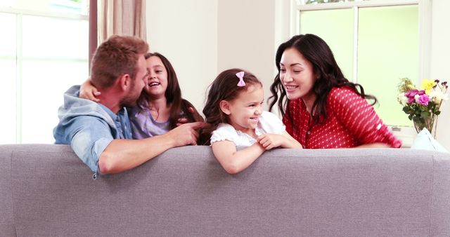 Happy Family Laughing and Playing Together on Couch - Download Free Stock Images Pikwizard.com