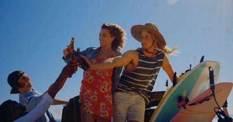 Joyful Friends Celebrating Beach Adventure with Drinks