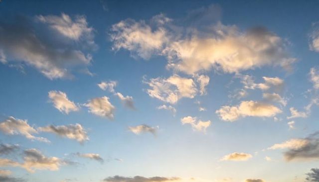Golden Sunrise Clouds Scattering Light Across Expansive Blue Sky, Serene Morning Glow Pastel