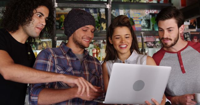 Group of Young Diverse Friends Watching Laptop Together in Comic Book Store - Download Free Stock Images Pikwizard.com