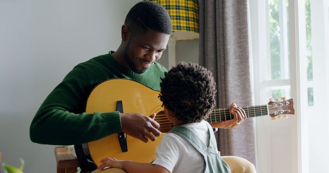 Father Teaching Young Son Acoustic Guitar at Home - Download Free Stock Images Pikwizard.com