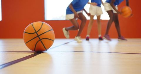 Diverse Female Basketball Team Practicing on Gym Court