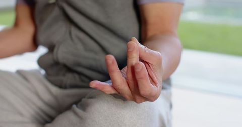 Mature Man Meditating Indoors by Window
