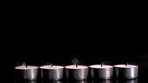 Five Flickering Tealight Candles Extinguishing Sequentially