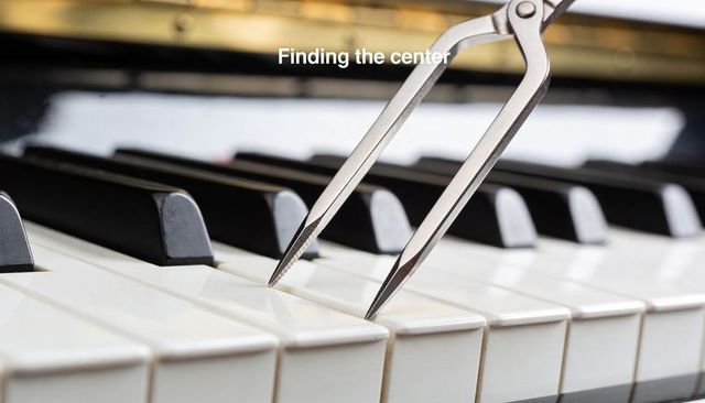 Finding center with tuning caliper touching piano key closeup for precision tuning