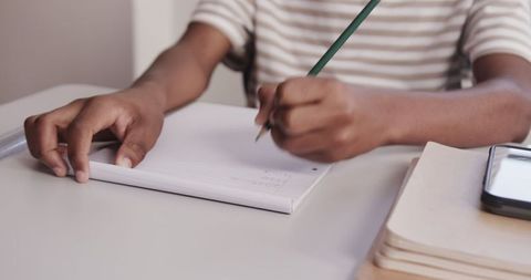 Student Studying and Writing in Notebook at Desk - Download Free Stock Images Pikwizard.com