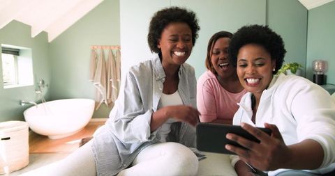 Women Sharing Happy Moments with Smartphone in Bathroom