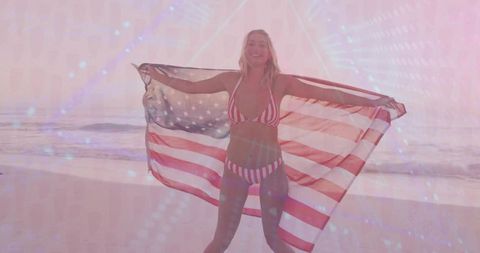 Woman Embracing Freedom with American Flag on Beach at Sunrise