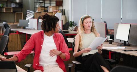 Colleagues Collaborating on Project Ideas in Modern Office