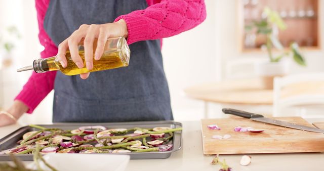 Woman preparing vegetables with olive oil in kitchen - Download Free Stock Images Pikwizard.com