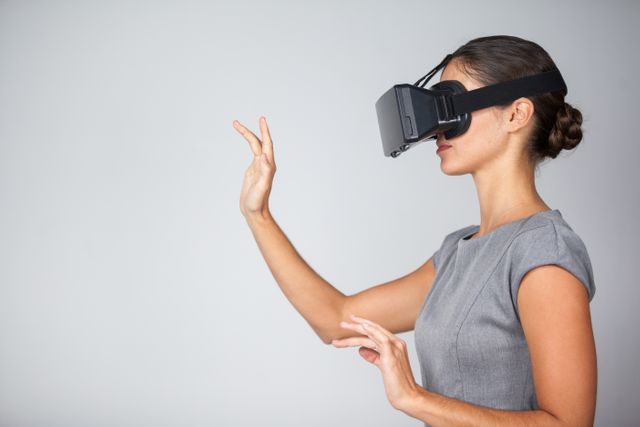 Woman using virtual reality headset against white background