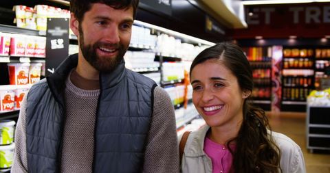 Smiling Couple Shopping Together in Supermarket Aisle - Download Free Stock Images Pikwizard.com
