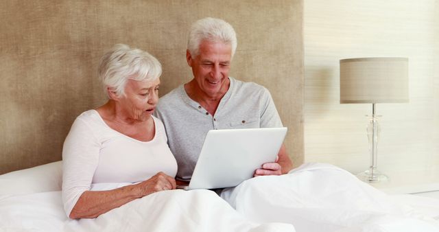 Senior Couple Relaxing in Bed with Digital Tablet - Download Free Stock Images Pikwizard.com