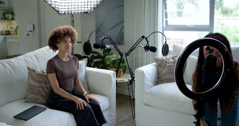 African American Women Recording Podcast in Home Studio With Microphones and Ring light