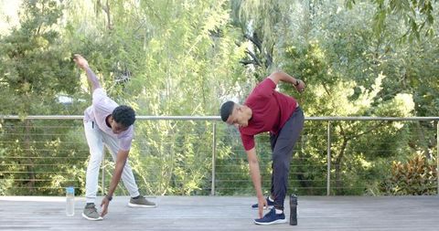 Diverse Friends Stretching Outdoors Amid Lush Greenery