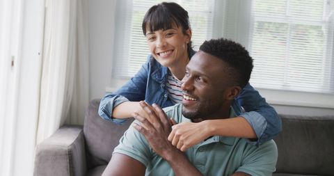 Happy Diverse Couple Relaxing on Couch in Bright Living Room - Download Free Stock Images Pikwizard.com