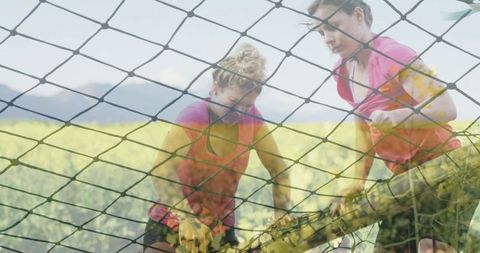 Women Challenging Rope Obstacle in Outdoor Adventure Course