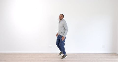 Joyful Man Jumping with Energy in Casual Attire - Download Free Stock Images Pikwizard.com