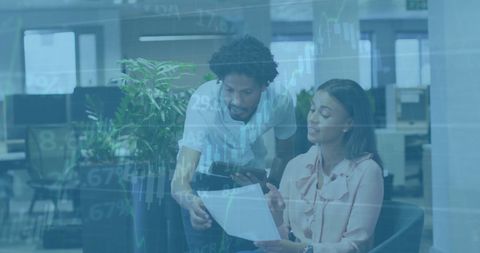 Diverse professionals discuss financial data in modern office