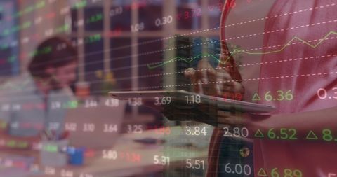 Multi-tasking Businesswoman Analyzing Financial Data on Tablet in Modern Office