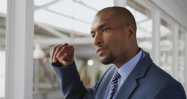 Pensive Businessman Looking Through Office Window - Download Free Stock Images Pikwizard.com