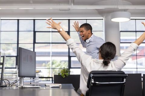 Coworkers Celebrating Success in Vibrant Office Environment