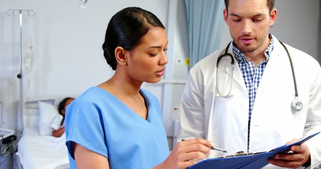 Medical team composed of multiethnic doctor and nurse reviewing patient records in a hospital. Ideal for depicting teamwork in healthcare settings, medical consultations, professional collaboration, health assessments, and hospital practices.