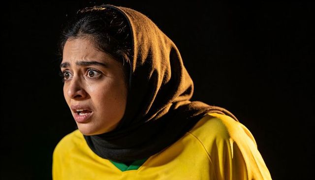 Dramatic closeup hijab-wearing woman showing alarm and tension while looking left