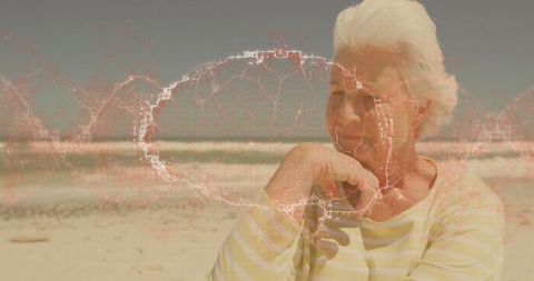 Senior Woman Relaxing on Beach with Digital Network Overlay