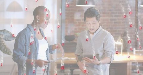 Collaborating on tablet with binary data overlay in modern industrial office workspace
