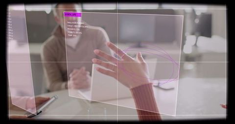 Ringed woman gesturing over augmented reality interface with tablet in teamwork meeting