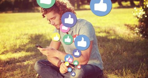 Man Relaxing in Park Engaging with Social Media Outdoors