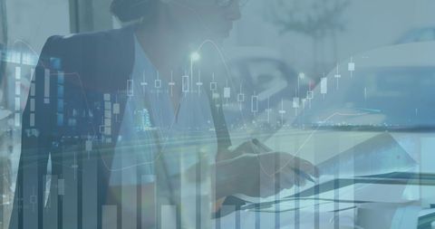Businesswoman analyzing financial charts in modern office setting